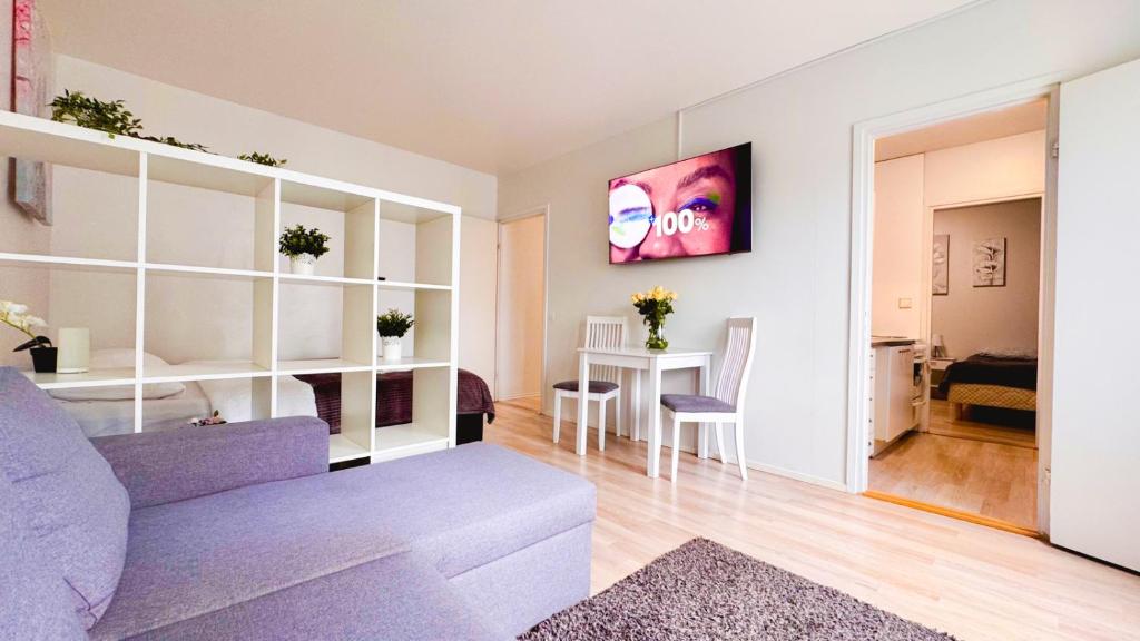 a living room with a couch and a table at Central 2-Room apartment in Oulu, parking in Oulu