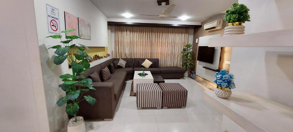 a living room with a couch and a table at Spacious 2BR Portion with Rooftop Gulshan e Iqbal Block 7 in Karachi