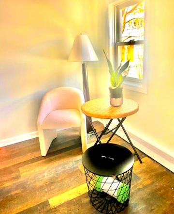 a room with a table and a chair and a stool at 2-bed rm house on the lake in Merrimac