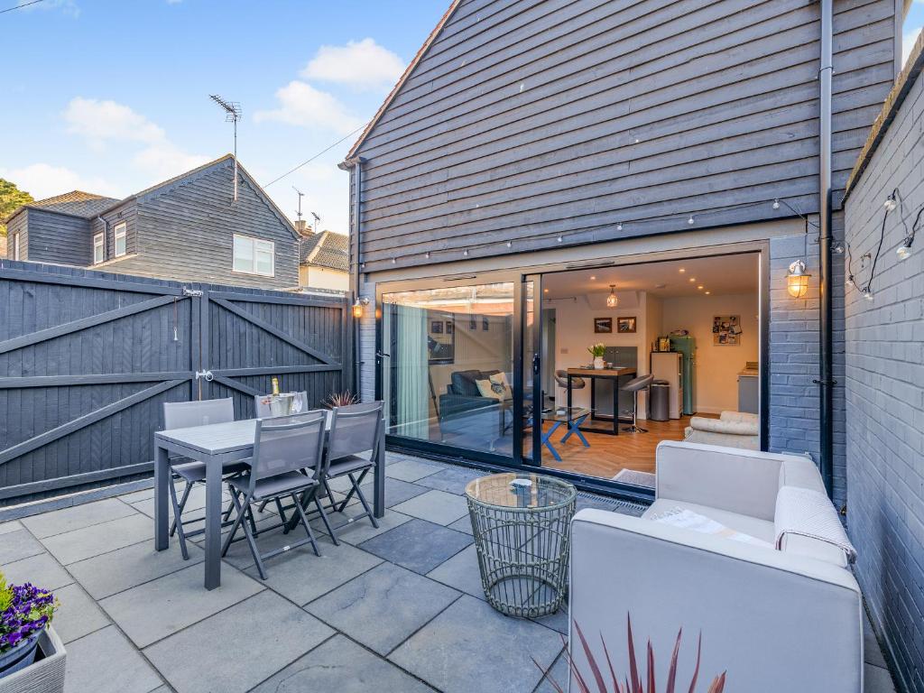 a patio with a white couch and a table at Harbour Lodge - Uk49490 in Whitstable