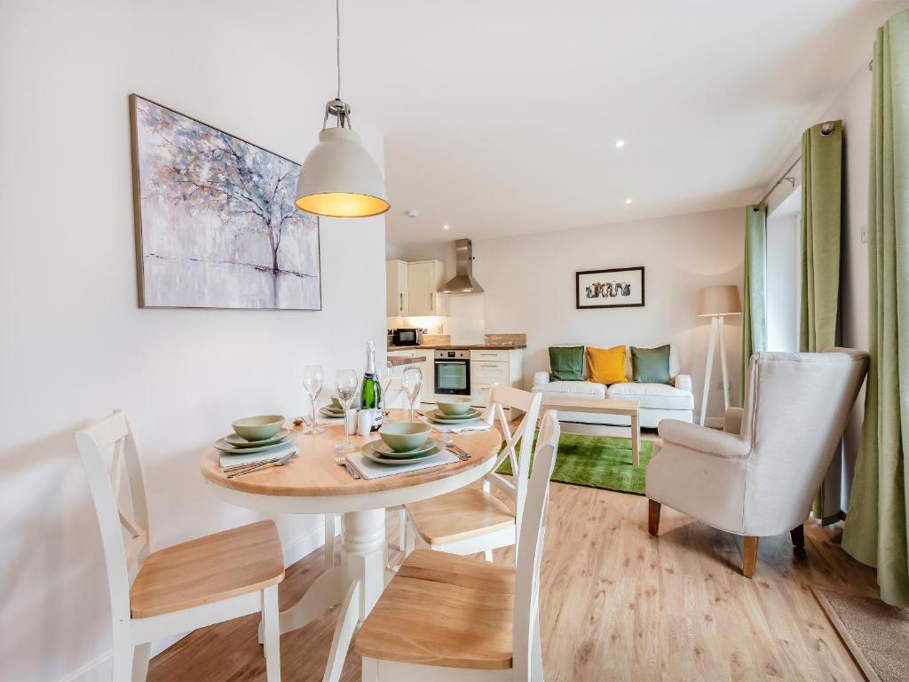 a dining room and living room with a table and chairs at Dairy Cottage-Ukc5158 in Shootend