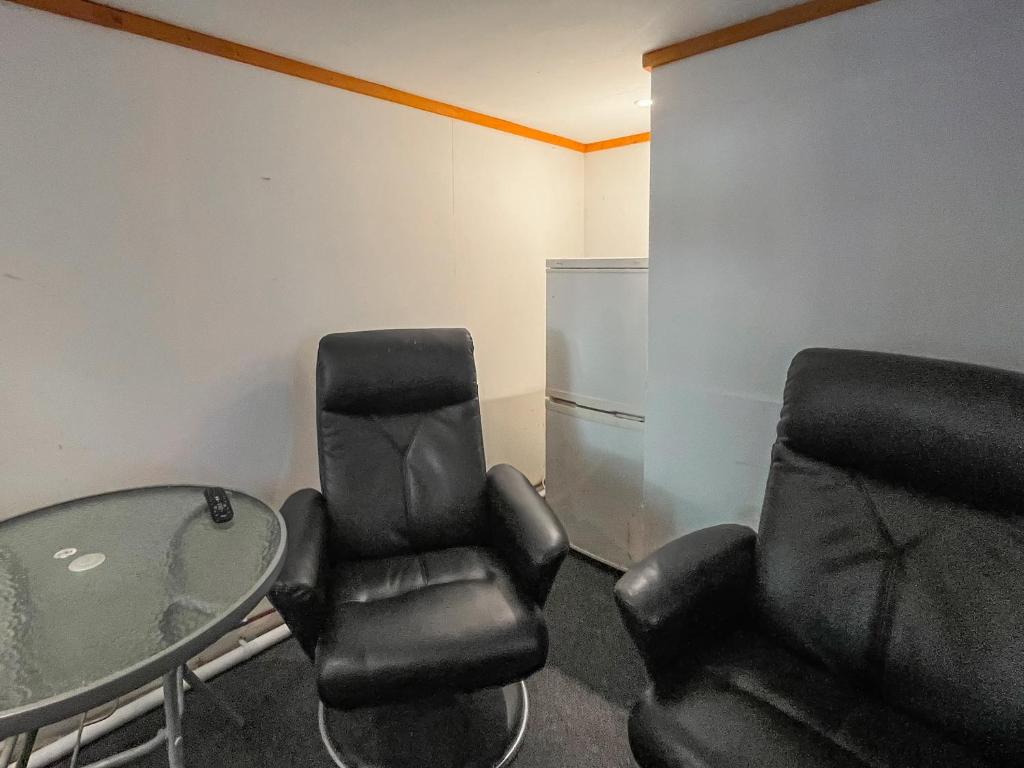 a room with two chairs and a glass table at Seaside in Peacehaven