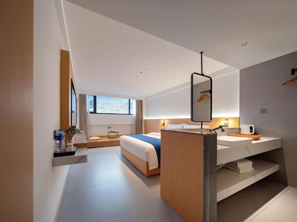 En eller flere senge i et værelse på Zhangjiajie Zhenxi Hotel