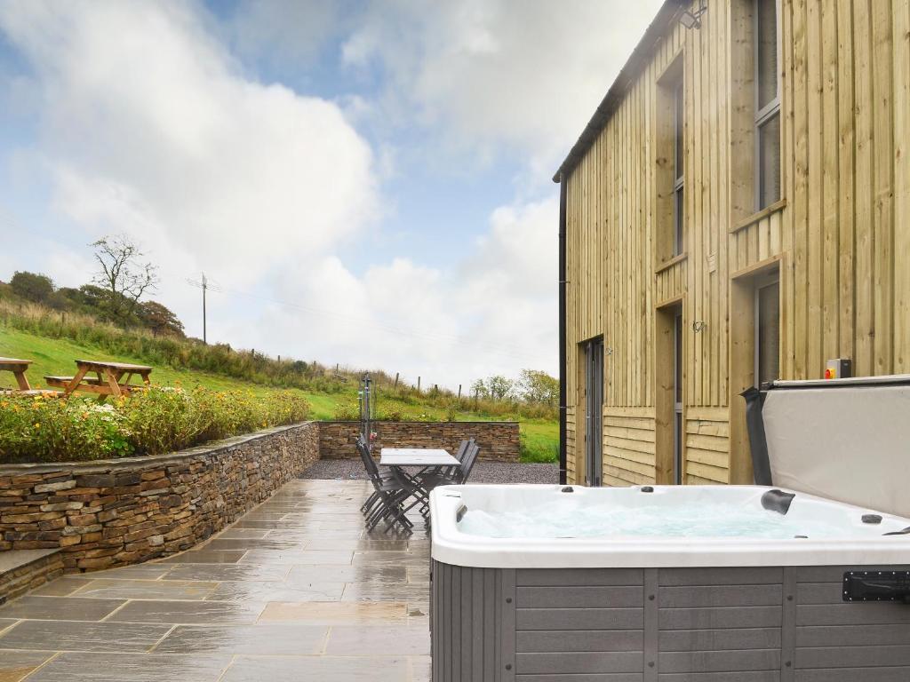 a bath tub sitting next to a building at Heartwell Cottage in Wolsingham