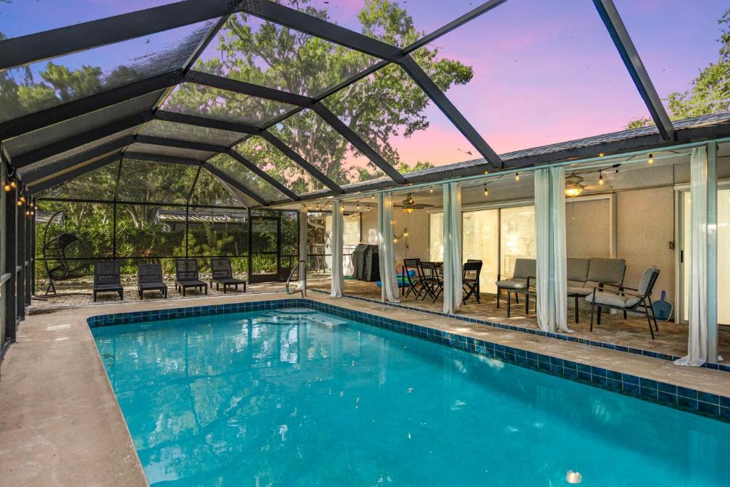 サラソタにあるHighland Cove Hideawayのパーゴラ付きの家のスイミングプール