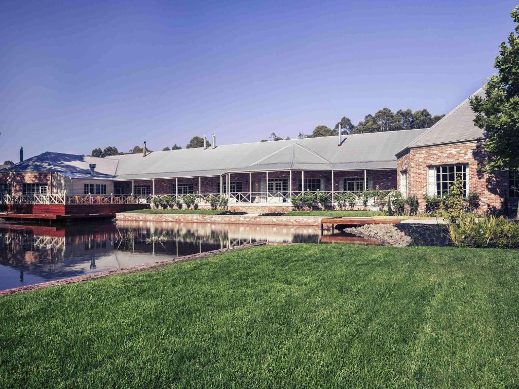 a large building with a river in front of it at Mercure Ballarat Hotel & Convention Centre in Ballarat
