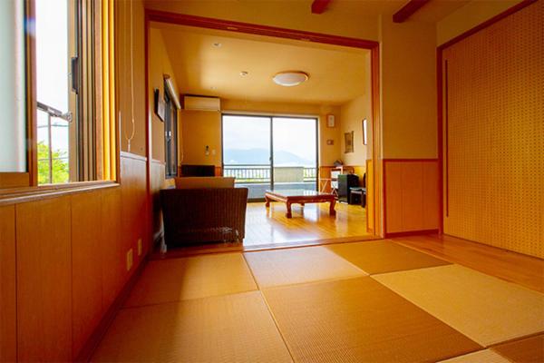 a room with a view of a living room at 民宿かまだ MinshukuKamada in Hatsukaichi
