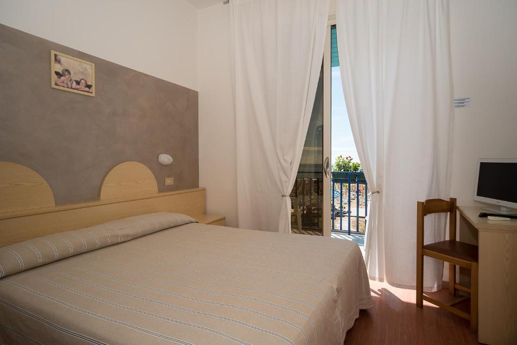 Postel nebo postele na pokoji v ubytování Hotel Conchiglia