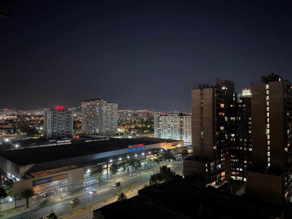 a city skyline at night with buildings and lights at Departamento en Maule, cerca Estadio Nacional y metro Ñuble in Santiago