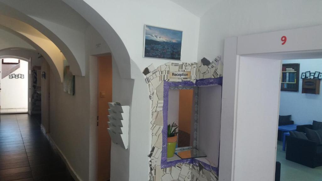 a hallway with a wall with a painting on it at Hostel Sleeping Beauty in Ljubljana