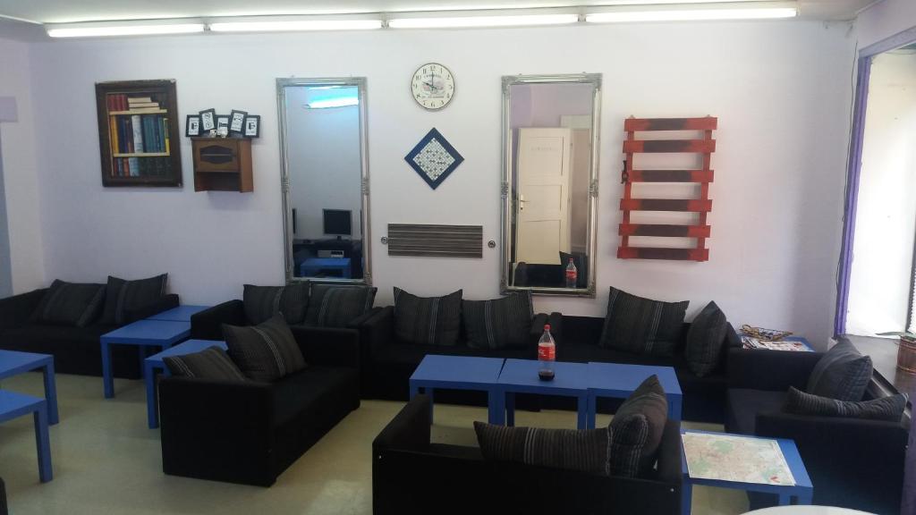 a living room with couches and a blue table at Hostel Sleeping Beauty in Ljubljana