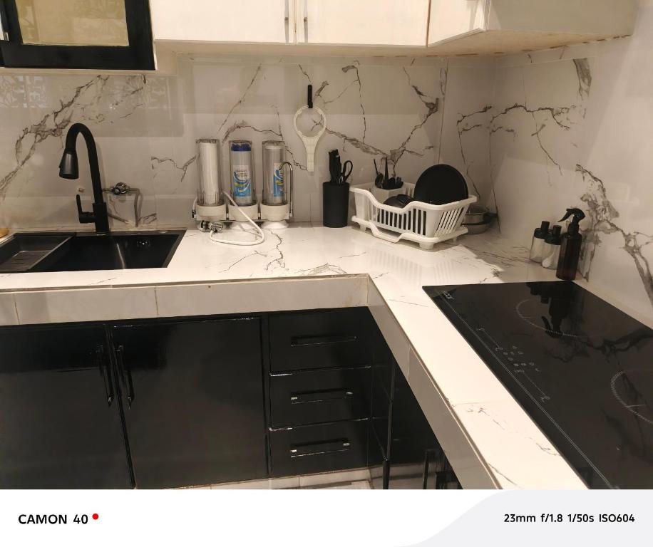 a kitchen with a sink and a counter top at CBD Studio Loft 2A at City Center! in Medan