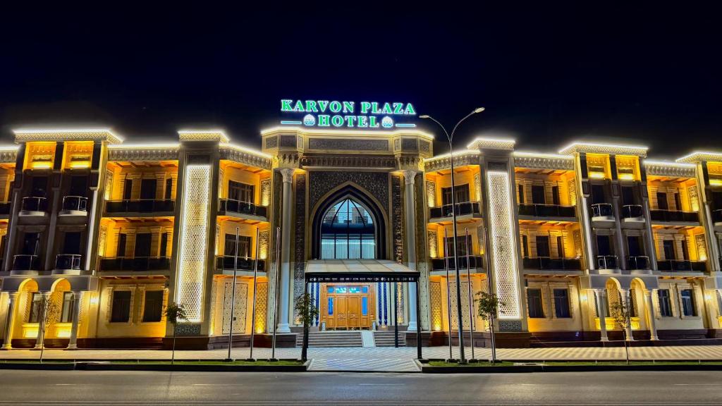 a building with a sign on the front of it at Karvon Plaza Hotel in Samarkand