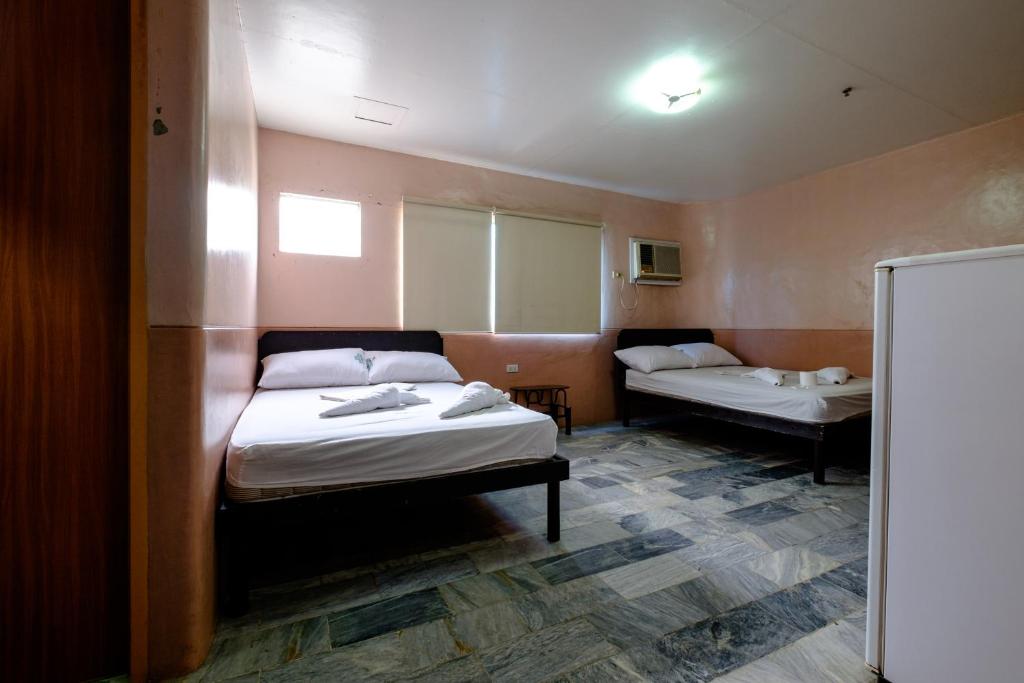 Postel nebo postele na pokoji v ubytování GV Hotel - Ozamiz