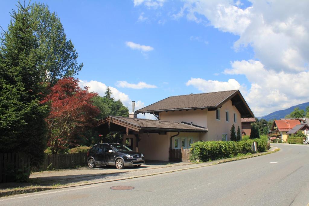 a car parked in front of a house on a street at Haus Eberl in Bruck an der Großglocknerstraße