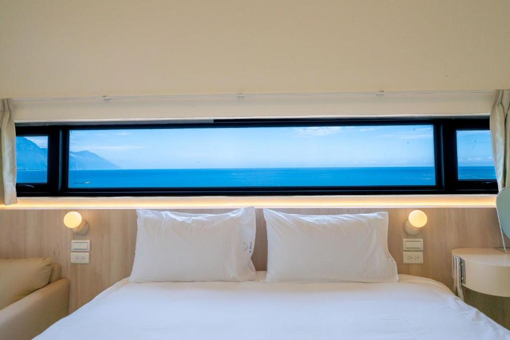 Ένα ή περισσότερα κρεβάτια σε δωμάτιο στο 冉冉七星潭海景民宿