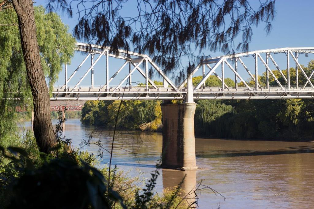 a bridge over a river with a bridge over water at Riverside Lodge & Conference Center in Aliwal North