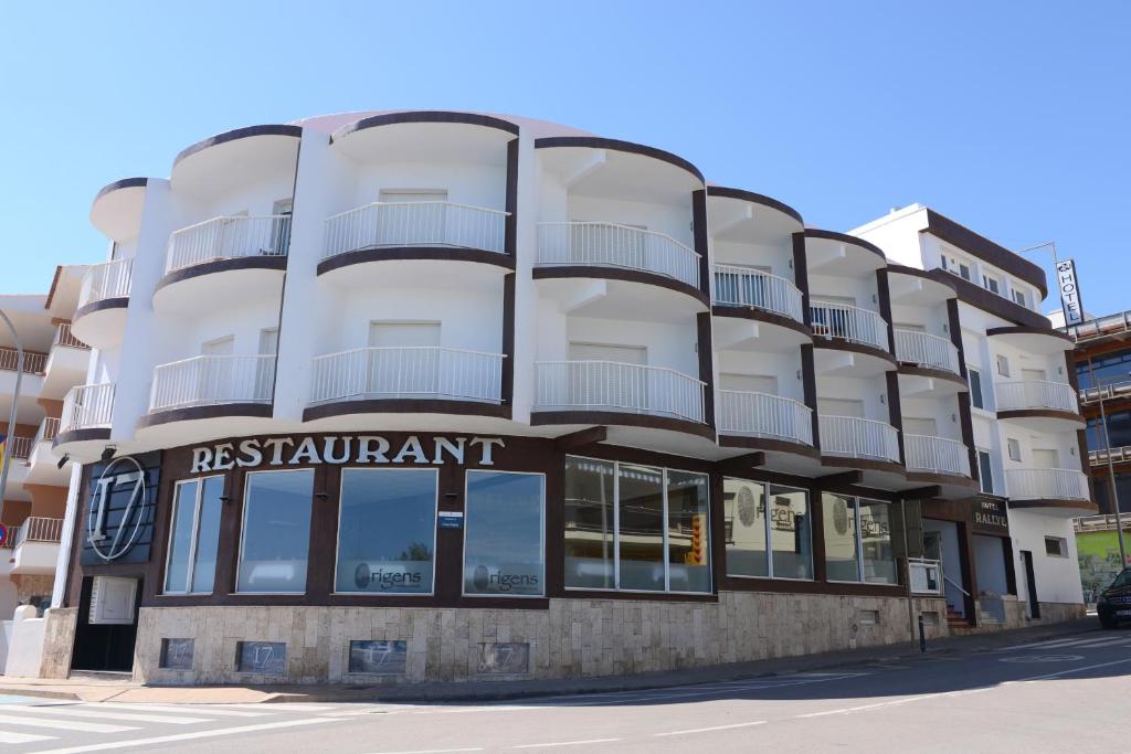 a apartment building with a sign for a restaurant at Rallye Hotel in L'Escala