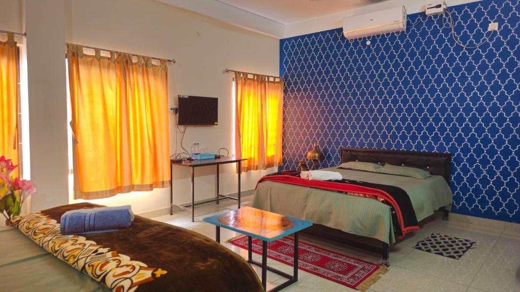 a bedroom with a bed and a couch at Nilachal Homes in Guwahati