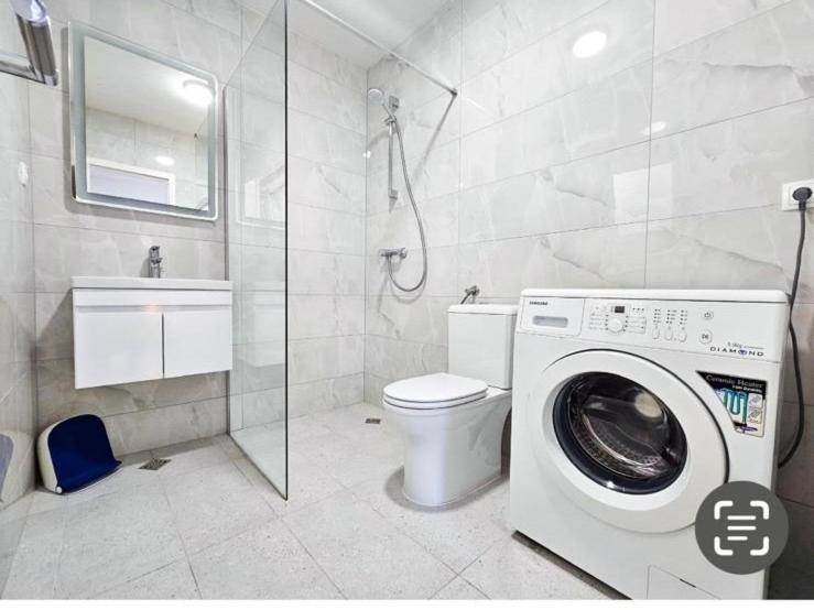 a bathroom with a washing machine and a toilet at D-Spot apartments Pišta in Zaostrog
