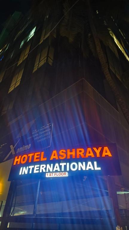 a hotel ashtarhtar international sign on the side of a building at Hotel Ashraya International in Mumbai