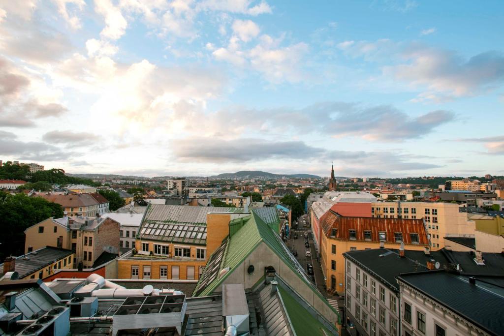 a city skyline with buildings and a cloudy sky at Comfort Hotel Xpress Youngstorget in Oslo