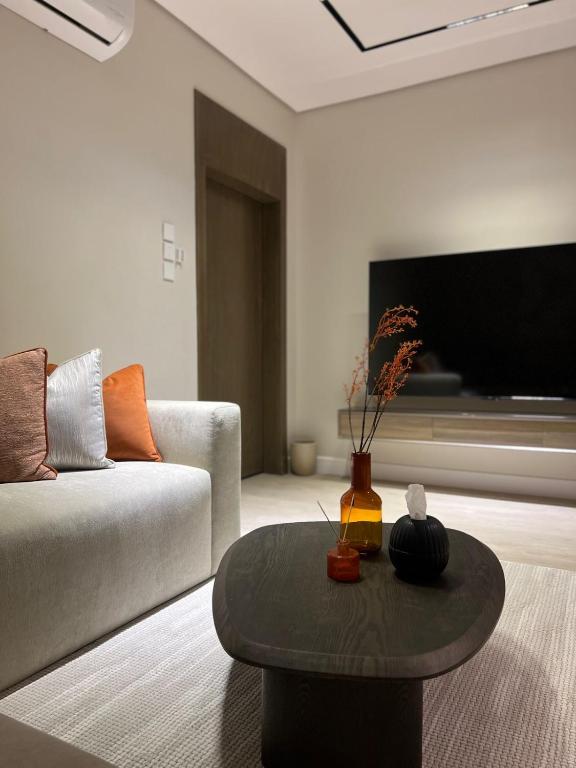 a living room with a couch and a coffee table at 101 - Comfy Space - 80TV smart - Self Check-in in Riyadh