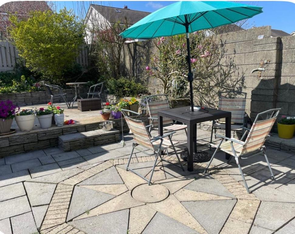 a table and chairs with an umbrella on a patio at Quiet Room in Wexford with Local Charm in Wexford
