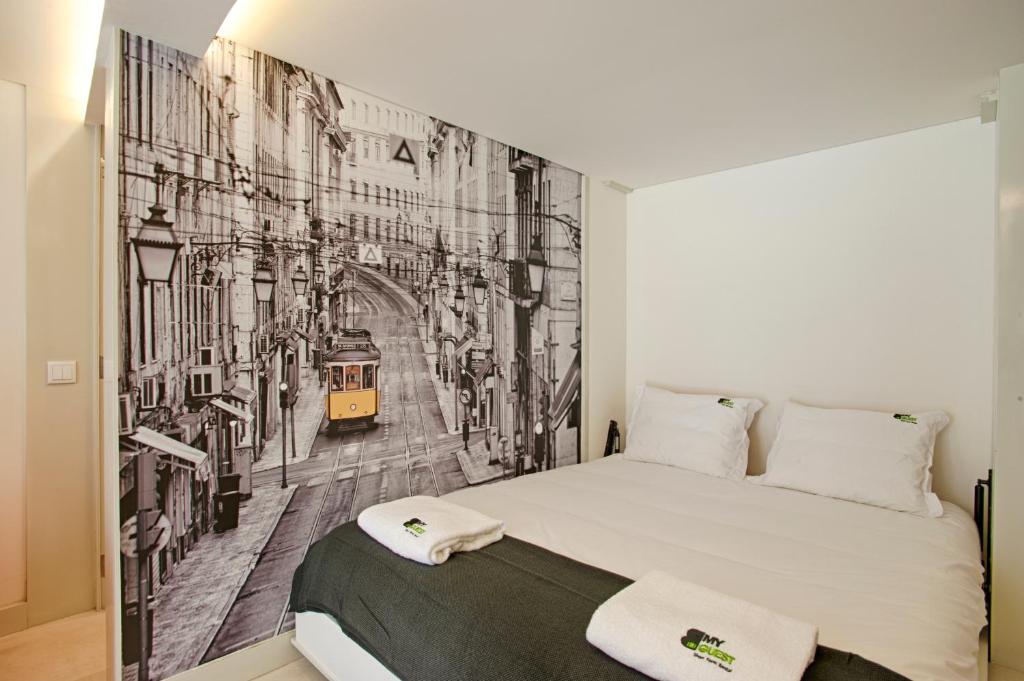 a bedroom with a wall mural of a city at BmyGuest - Alfama Boutique Apartment in Lisbon