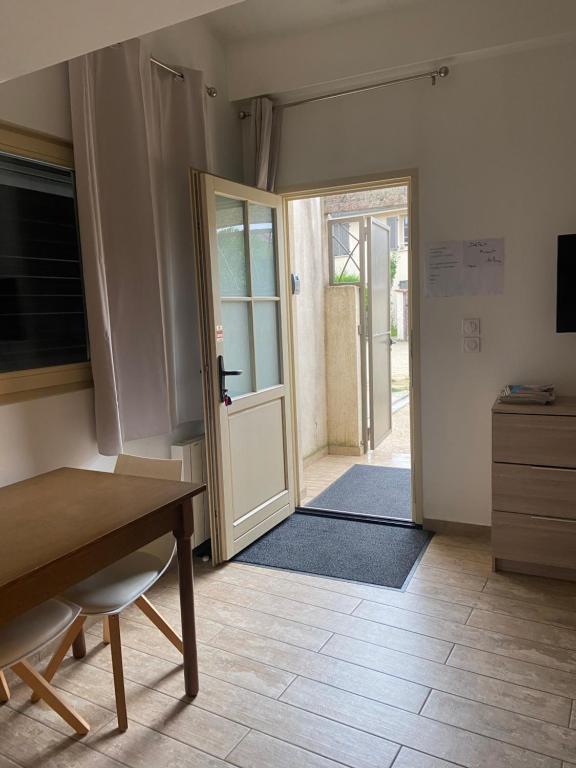 a room with a door open to aoyer with a table at Le Miribel in Miribel