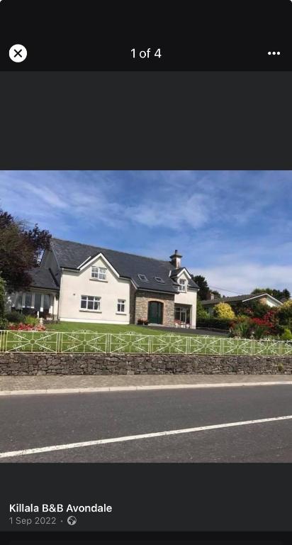 a white house on the side of a road at Killala B&B Avondale in Killala