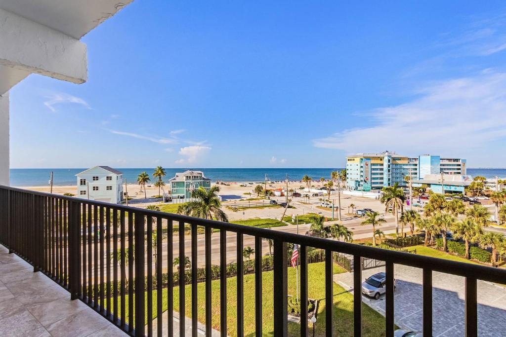 a balcony with a view of the beach and buildings at 1511 Seas The Day- Batiki West Unit #504 condo in Fort Myers Beach
