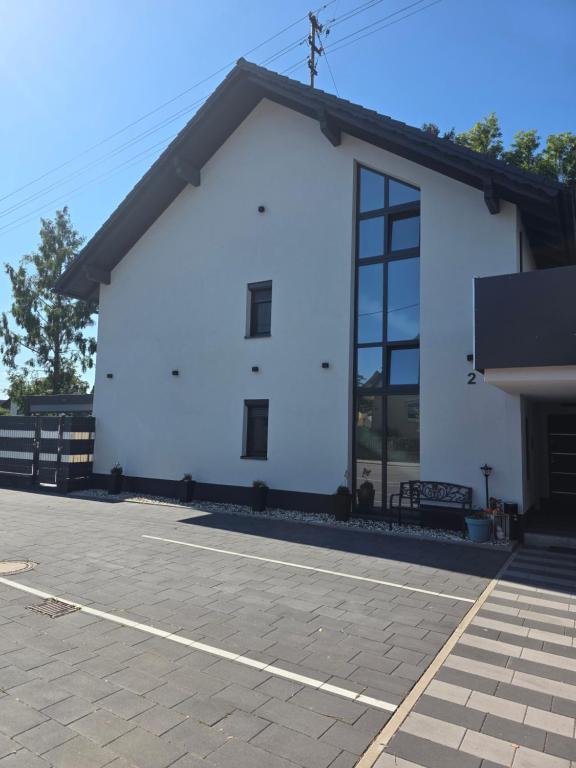 a white building with a lot of windows at Dachgeschoss Wohnung in Langerringen