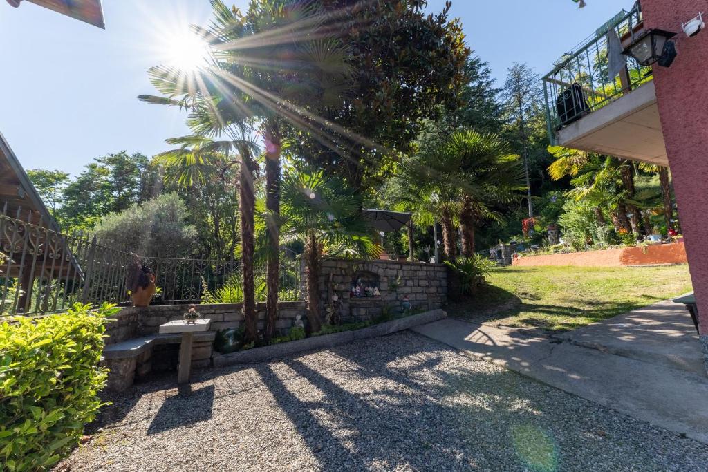 a park with a bench next to a fence at Inas Lake Garden Elias Suite, Como Lake in Lenno