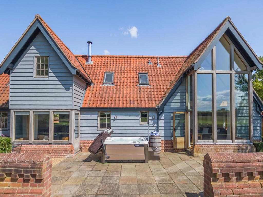 a house with a pool in front of it at Wittle Cottage in Quidenham