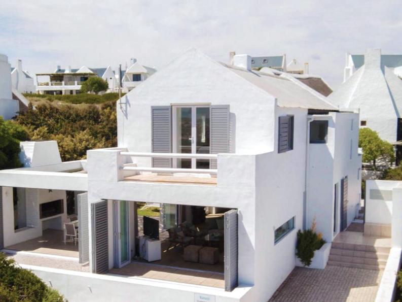 a white house with a view of the ocean at Namaste - Sea-facing 4 sleeper Holiday Home in Paternoster