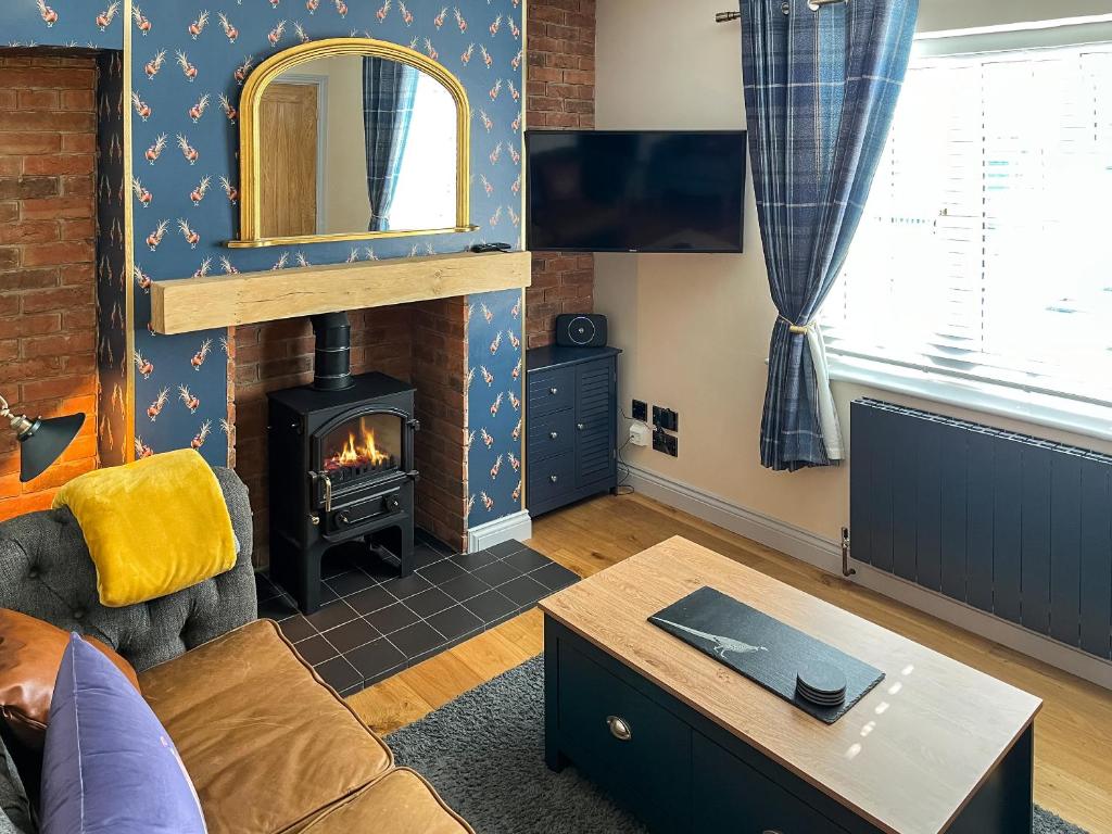 a living room with a couch and a fireplace at Lily Pad - Uk49104 in Helmsley