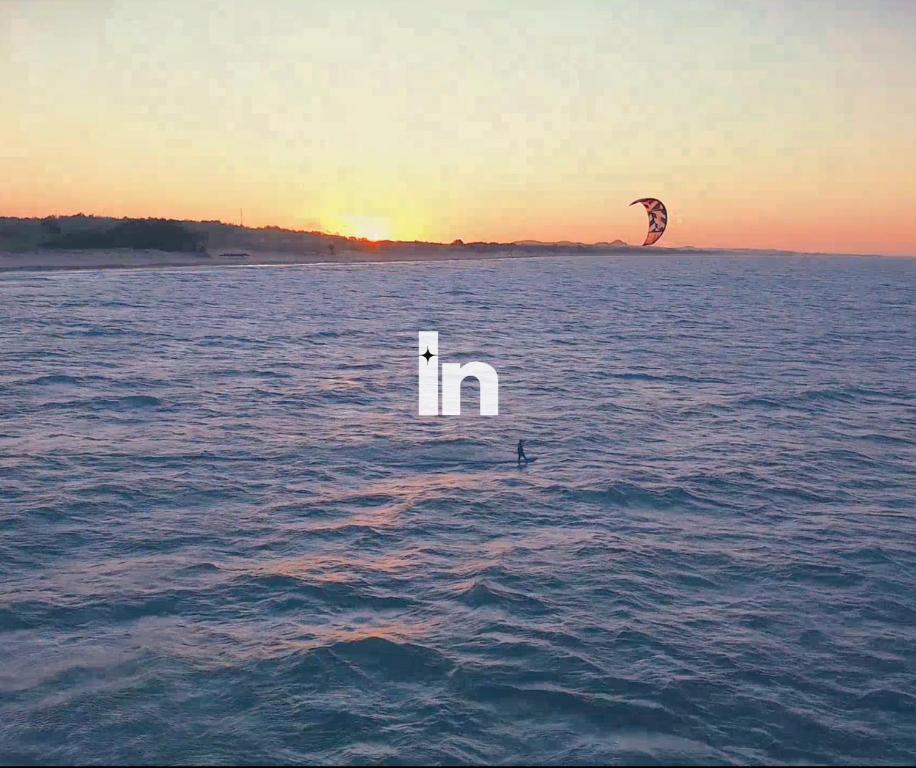 a person in the water with a kite in the ocean at Casa - Summerville Cumbuco I By Inspira Ceará in Guagiru