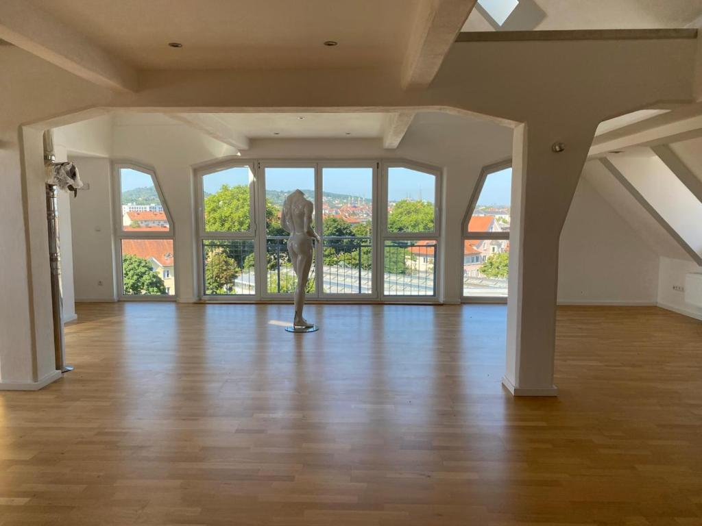 a large room with a statue in front of windows at Vorverkauf Penthouse Loft Bamberg in Bamberg