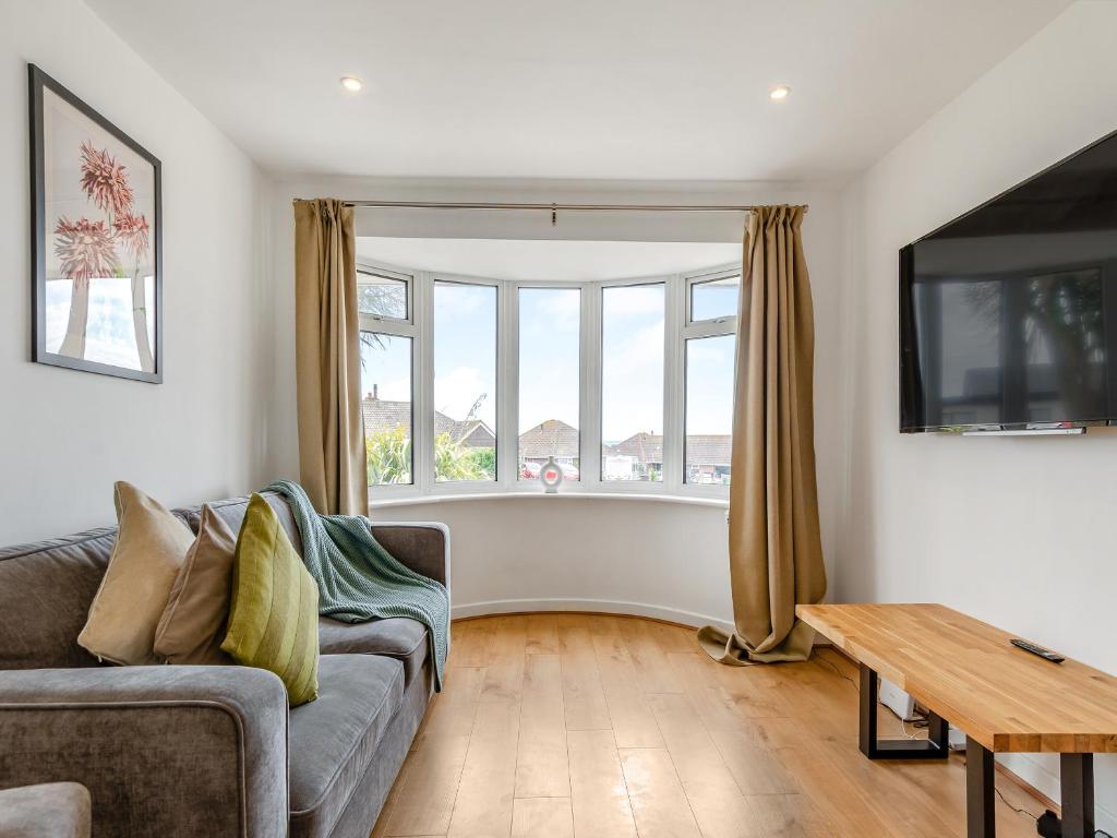 a living room with a couch and a table at Beach House in Seaford