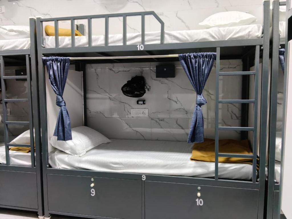 a bunk bed room with two bunk beds at BASERA DORMITORY ANDHERI - Marol in Mumbai