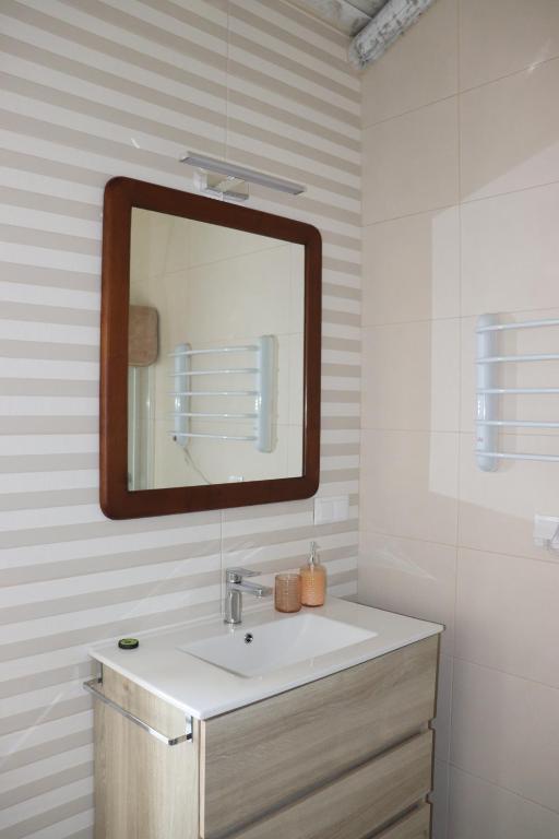 a bathroom with a sink and a mirror at Casa da Moura in Santiago do Cacém