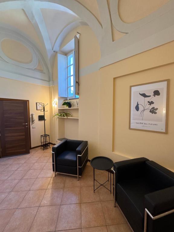 a waiting room with black furniture and a window at Casa dell'Edera T in Orvieto