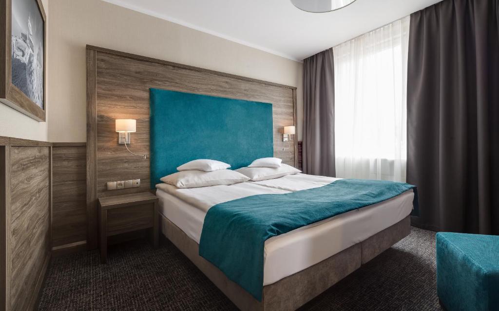 Postel nebo postele na pokoji v ubytování Hotel Konradówka Wellness & SPA - 300 metrów do centrum
