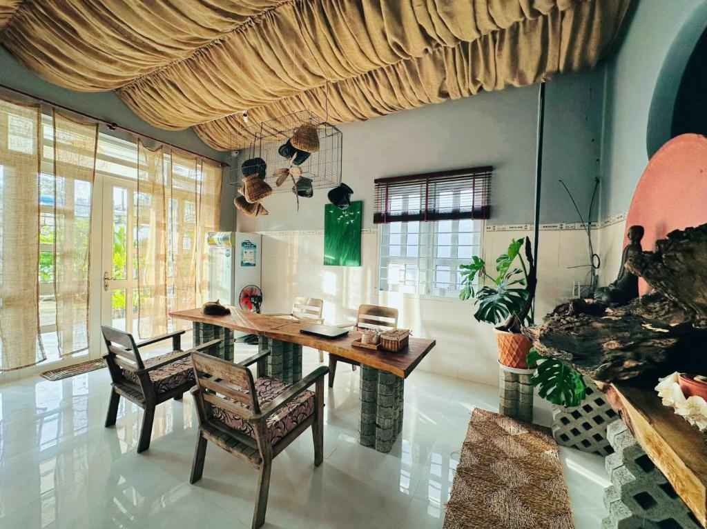 a dining room with a wooden table and chairs at Entire Garden House in Con Dao ! 3BR & 4WC ! Private Yard with Washer & Dryer in Con Dao