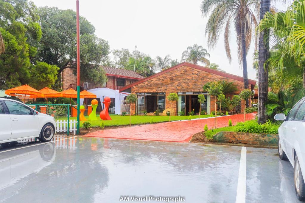 a car parked in front of a house in the rain at Beyond borders boutique hotel in Polokwane