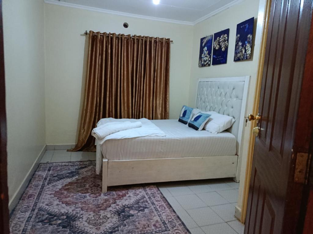 a small bedroom with a bed and a window at Blissful abode in Kisumu