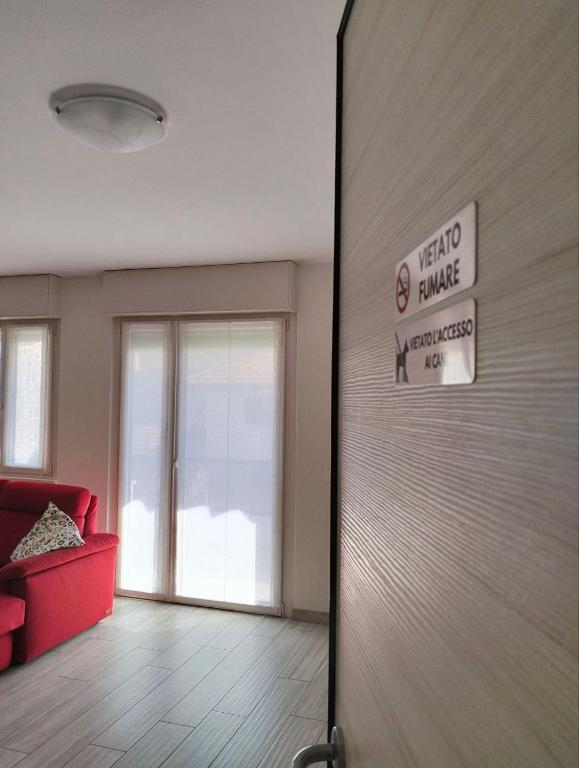 a sliding door in a living room with a red couch at Casa Alla Veduta in Trento