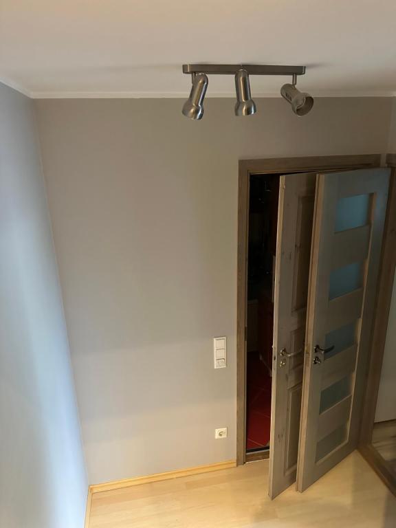 an empty room with a door and lights on the ceiling at MAjAKA in Tallinn