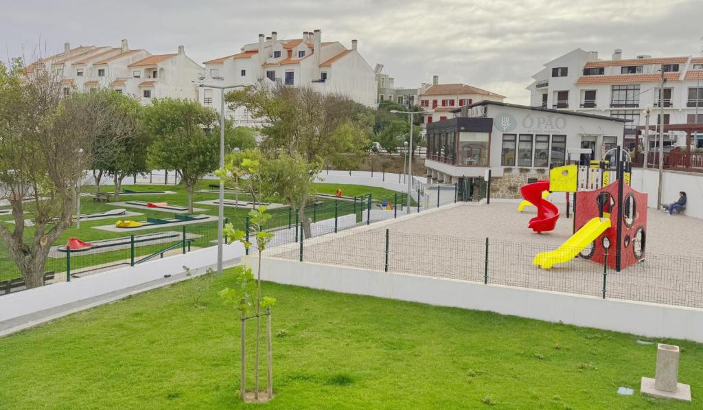 a playground with a slide in a park at Ribeiro house in Lourinhã